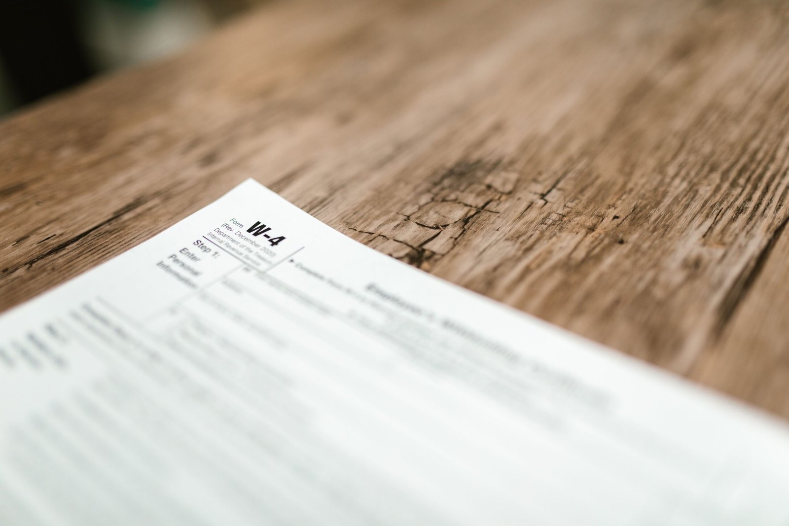 Employee completing IRS Form W-4 for tax withholding